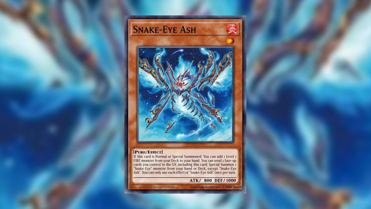 A picture of the Yu-Gi-Oh! card Snake-Eye Ash on a blurred background of its artwork. The card depicts an enigma made out of blue fire that appears to have four wings and a snake-like tail. It is flying in front of a blue background. 